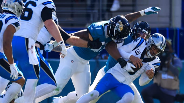 Carolina Panthers quarterback Bryce Young (9) is sacked by Jacksonville Jaguars linebacker Travon Walker (44) and as linebacker Josh Allen (41) looks on during the second quarter of a regular season NFL football matchup Sunday, Dec. 31, 2023 at EverBank Stadium in Jacksonville, Fla. The Jacksonville Jaguars blanked the Carolina Panthers 26-0. [Corey Perrine/Florida Times-Union]