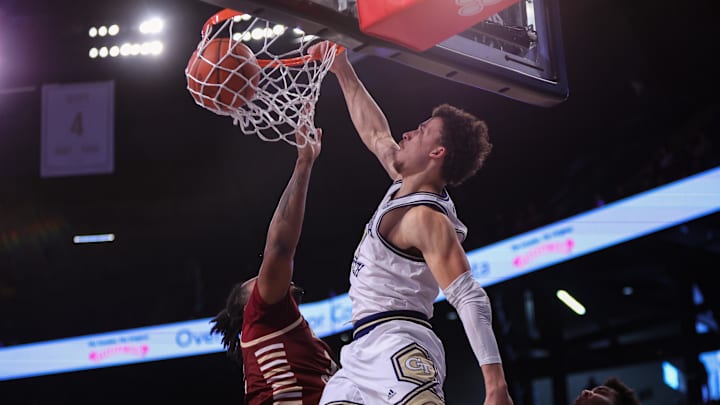 Jan 4, 2025; Atlanta, Georgia, USA; Georgia Tech Yellow Jackets guard Lance Terry (0) dunks over Boston College Eagles forward Chad Venning (32) in the second half at McCamish Pavilion. Mandatory Credit: Brett Davis-Imagn Images
