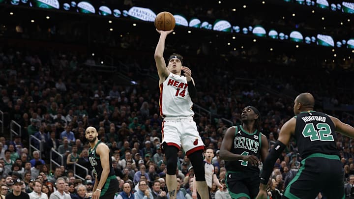 May 1, 2024; Boston, Massachusetts, USA; Miami Heat guard Tyler Herro (14) shoots as Boston Celtics guard Jrue Holiday (4) looks on during the first quarter of game five of the first round of the 2024 NBA playoffs at TD Garden. Mandatory Credit: Winslow Townson-Imagn Images