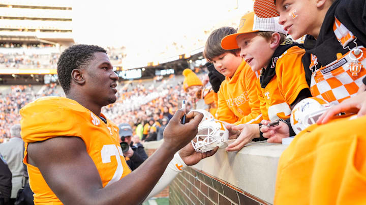 Tennessee defensive lineman James Pearce Jr. autographs items for children after a college football game between Tennessee and UTEP at Neyland Stadium in Knoxville, Tennessee, on Saturday, Nov. 23, 2024.