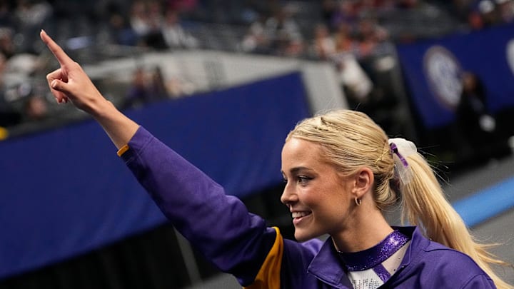 LSU gymnast LSU gymnast Livvy Dunne walks with teammates to a competition area and gestures to fans during Session 2 of the SEC Gymnastics Championship at Legacy Arena in Birmingham, Alabama. LSU won the event to claim the SEC crown on March 22.