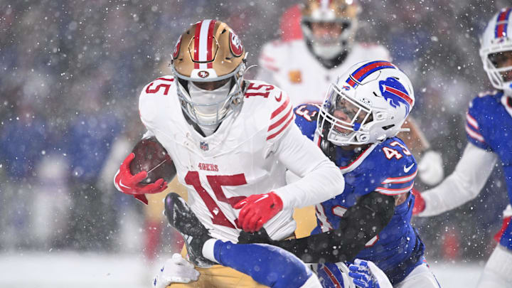 Dec 1, 2024; Orchard Park, New York, USA; San Francisco 49ers wide receiver Jauan Jennings (15) is tackled by Buffalo Bills linebacker Terrel Bernard (43) after making a catch in the third quarter at Highmark Stadium