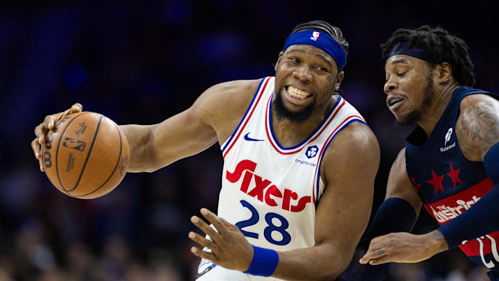 Jan 8, 2025; Philadelphia, Pennsylvania, USA; Philadelphia 76ers forward Guerschon Yabusele (28) drives against Washington Wizards forward Richaun Holmes (22) during the fourth quarter at Wells Fargo Center. Mandatory Credit: Bill Streicher-Imagn Images