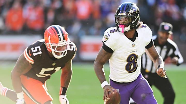 Oct 27, 2024; Cleveland, Ohio, USA; Baltimore Ravens quarterback Lamar Jackson (8) scrambles from Cleveland Browns defensive tackle Mike Hall Jr. (51) during the second half at Huntington Bank Field. Mandatory Credit: Ken Blaze-Imagn Images