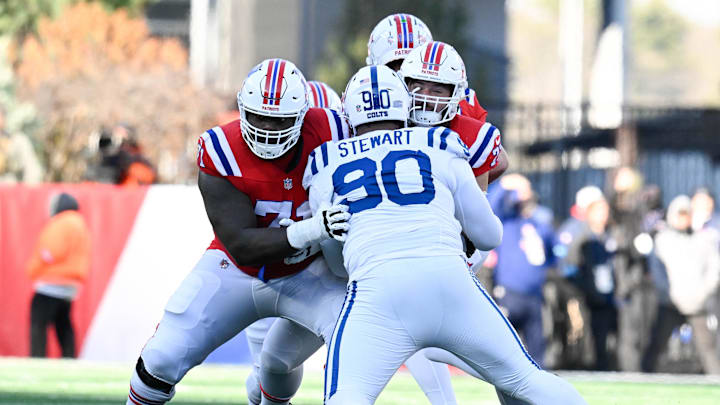 Dec 1, 2024; Foxborough, Massachusetts, USA; New England Patriots offensive tackle Mike Onwenu (71) blocks Indianapolis Colts defensive tackle Grover Stewart (90) during the first half at Gillette Stadium. Mandatory Credit: Eric Canha-Imagn Images