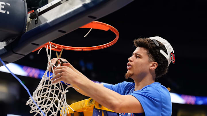 Florida guard Walter Clayton Jr. (1) cuts down his piece of the net as the team celebrates their win over Tennessee after the Southeastern Conference tournament championship at Bridgestone Arena in Nashville, Tenn., Sunday, March 16, 2025.