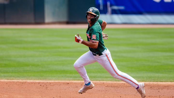 May 23, 2024; Charlotte, NC, USA; Miami (Fl) Hurricanes infielder Daniel Cuvet (14) heads to third against the Clemson Tigers in the second inning during the ACC Baseball Tournament at Truist Field. Mandatory Credit: Scott Kinser-Imagn Images