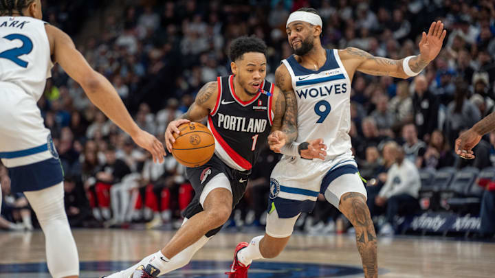 Feb 8, 2025; Minneapolis, Minnesota, USA; Portland Trail Blazers guard Anfernee Simons (1) dribbles against Minnesota Timberwolves guard Nickeil Alexander-Walker (9) in the second quarter at Target Center. Mandatory Credit: Matt Blewett-Imagn Images