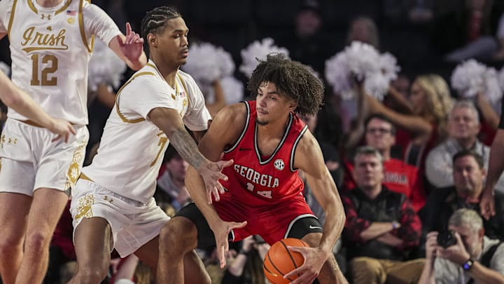 Dec 3, 2024; Athens, Georgia, USA; Georgia Bulldogs forward Asa Newell (14) controls the ball against Notre Dame Fighting Irish forward Tae Davis (7) during the second half at Stegeman Coliseum. Mandatory Credit: Dale Zanine-Imagn Images