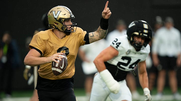 Vanderbilt quarterback Jared Curtis (2) directs his receivers while pressured by Vanderbilt linebacker Nick Rinaldi (24) during Vanderbilt Football's Black and Gold Spring Game in FirstBank Stadium at Vanderbilt University Saturday, April 18, 2026.
