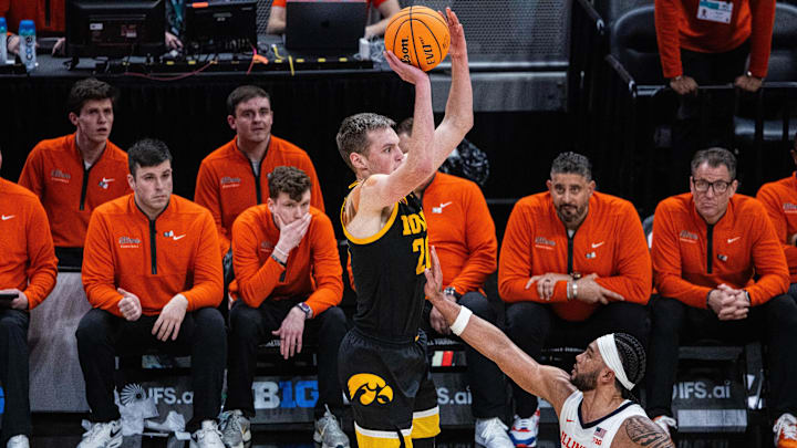 Mar 13, 2025; Indianapolis, IN, USA;  Iowa Hawkeyes forward Payton Sandfort (20) shoots the ball while Illinois Fighting Illini guard Kylan Boswell (4) defends in the first half at Gainbridge Fieldhouse. Mandatory Credit: Trevor Ruszkowski-Imagn Images