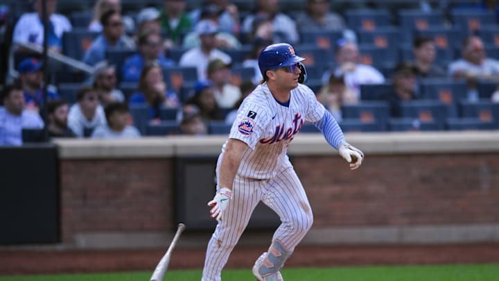 Sep 21, 2025; New York City, New York, USA; New York Mets first baseman Pete Alonso (20) hits a single against the Washington Nationals during the eighth inning at Citi Field. Mandatory Credit: John Jones-Imagn Images