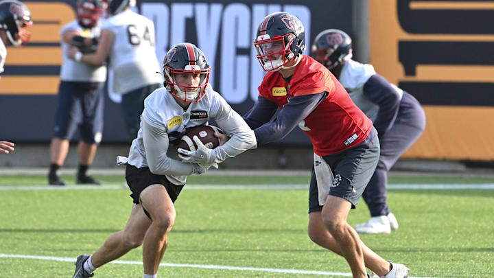 Nov 16, 2023; Hamilton, Ontario, CAN;  Montreal Alouettes quarterback Cody Fajardo (7) hands the ball off to wide receiver Tyler Snead (85) during practice at Tim Hortons Field. Mandatory Credit: Dan Hamilton-Imagn Images