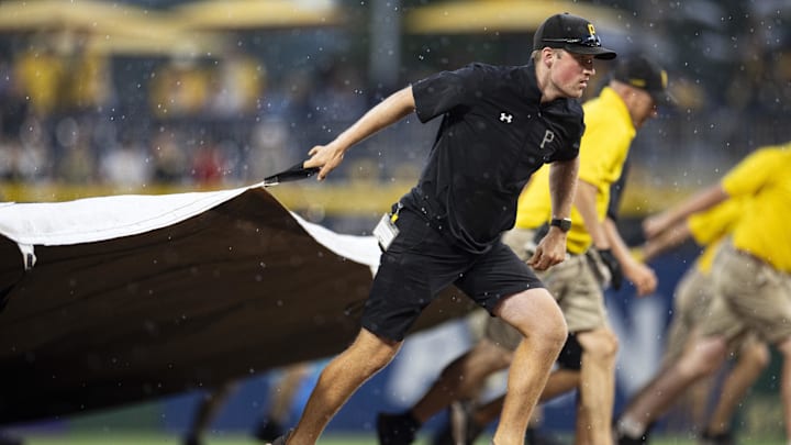 Jul 1, 2023; Pittsburgh, Pennsylvania, USA; The Pittsburgh Pirates grounds crew pull the tarp onto the field during a rain delay in the ninth inning against the Milwaukee Brewers at PNC Park. Mandatory Credit: Scott Galvin-Imagn Images