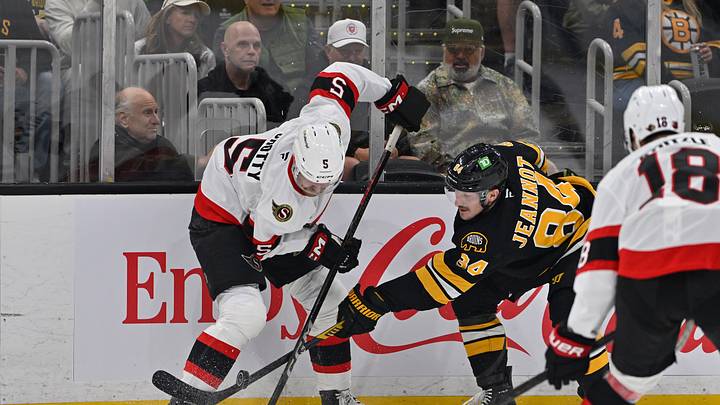 Oct 5, 2026; Boston, Massachusetts, USA; Boston Bruins left wing Tanner Jeannot (84) battles Ottawa Senators defenseman Cameron Crotty (5) for control of the puck during the first period at TD Garden. Mandatory Credit: Eric Canha-Imagn Images