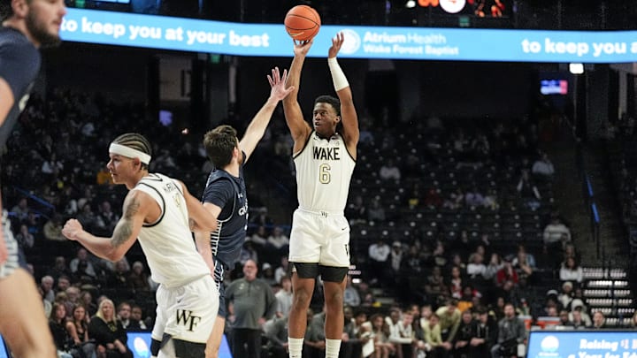Dec 14, 2025; Winston-Salem, North Carolina, USA; Wake Forest Demon Deacons guard Myles Colvin (6) shoots a jump shot over Queens University Royals guard Yoav Berman (24) during the first half at Lawrence Joel Veterans Memorial Coliseum. Mandatory Credit: Jim Dedmon-Imagn Images Dec 14, 2025; Winston-Salem, North Carolina, USA; Wake Forest Demon Deacons guard Myles Colvin (6) shoots a jump shot over Queens University Royals guard Yoav Berman (24) during the first half at Lawrence Joel Veterans Memorial Coliseum. Mandatory Credit: Jim Dedmon-Imagn Images