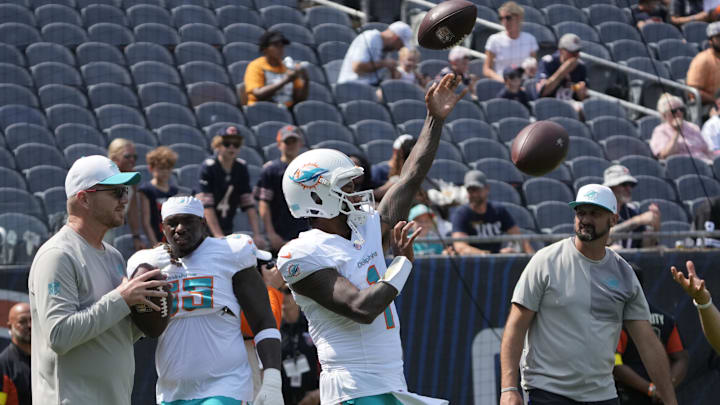 Miami Dolphins quarterback Tua Tagovailoa (1) warms up before a game against the Chicago Bears at Soldier Field.