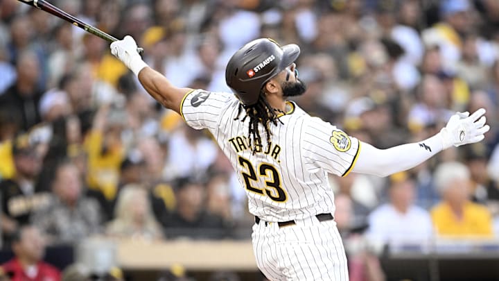 Oct 1, 2024; San Diego, California, USA; San Diego Padres outfielder Fernando Tatis Jr. (23) hits a two run home run against the Atlanta Braves during the first inning in game one of the Wildcard round for the 2024 MLB Playoffs at Petco Park.