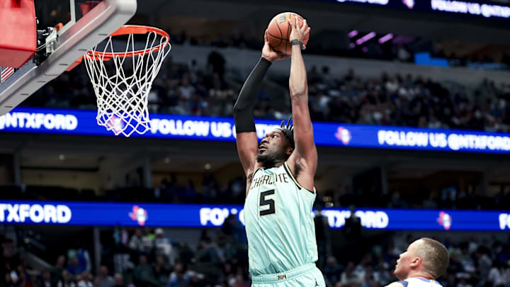 Feb 27, 2025; Dallas, Texas, USA;  Charlotte Hornets center Mark Williams (5) dunks past Dallas Mavericks guard Dante Exum (0) during the first half at American Airlines Center. Mandatory Credit: Kevin Jairaj-Imagn Images