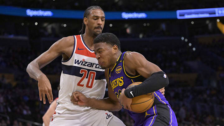 Jan 21, 2025; Los Angeles, California, USA;  Los Angeles Lakers forward Rui Hachimura (28) is defended by Washington Wizards forward Alexandre Sarr (20) as he drives to the basket in the second half at Crypto.com Arena. Mandatory Credit: Jayne Kamin-Oncea-Imagn Images