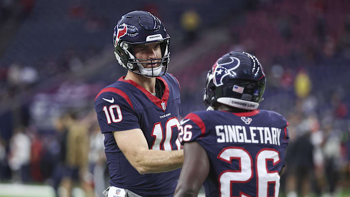 Dec 24, 2023; Houston, Texas, USA; Houston Texans quarterback Davis Mills (10) and running back