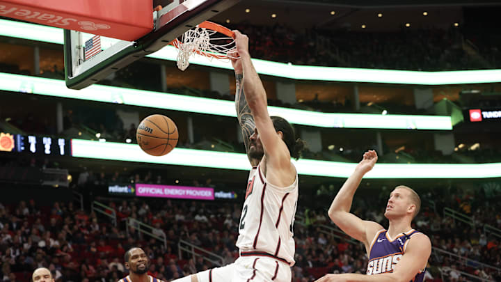 Feb 12, 2025; Houston, Texas, USA; Houston Rockets center Steven Adams (12) dunks against Phoenix Suns center Mason Plumlee (22) in the second half at Toyota Center. Mandatory Credit: Thomas Shea-Imagn Images
