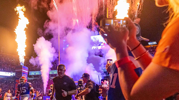 Florida Gators head coach Billy Napier runs out of the tunnel with the team as fireworks and fire shoot out of towers before the start of the game at Ben Hill Griffin Stadium in Gainesville, FL on Saturday, October 5, 2024. [Doug Engle/Gainesville Sun]