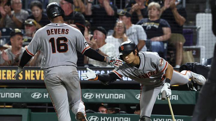 Pittsburgh, Pennsylvania, USA;  San Francisco Giants right fielder Jung Hoo Lee (right) congratulates first baseman Rafael Devers (16) after Devers scored a run against the Pittsburgh Pirates during the tenth inning at PNC Park.  Mandatory Credit: Charles LeClaire-Imagn Images