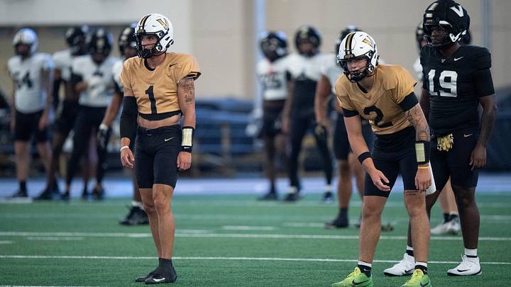 Vanderbilt quarterbacks Blaze Berlowitz (1) and Jared Curtis (2) go through warmups during preseason practice at the school’s indoor facility Friday, Aug. 14, 2026.
