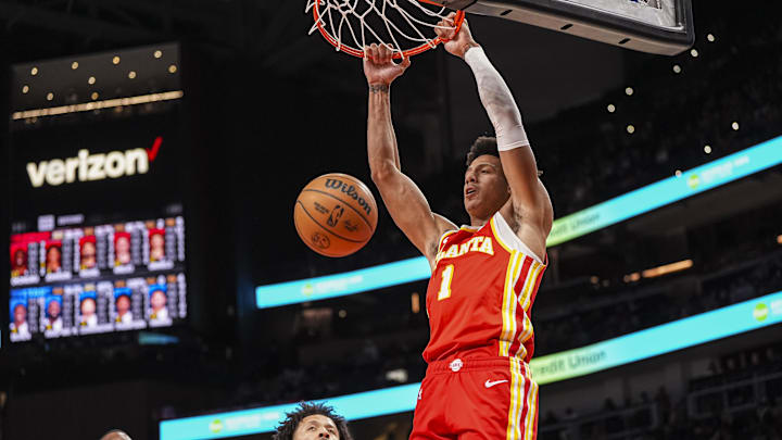 Jan 22, 2025; Atlanta, Georgia, USA; Atlanta Hawks forward Jalen Johnson (1) dunks the ball behind Detroit Pistons guard Cade Cunningham (2) during the second half at State Farm Arena. Mandatory Credit: Dale Zanine-Imagn Images