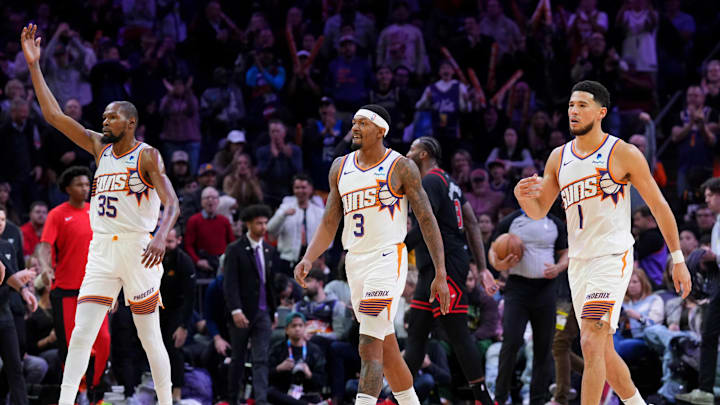 Jan 22, 2024; Phoenix, Arizona, USA; Phoenix Suns forward Kevin Durant (35) and Phoenix Suns guard Bradley Beal (3) and Phoenix Suns guard Devin Booker (1) reacts during the second half of the game against the Chicago Bulls at Footprint Center. Mandatory Credit: Joe Camporeale-Imagn Images