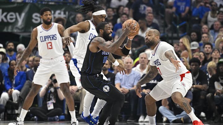 May 3, 2024; Dallas, Texas, USA; Dallas Mavericks guard Kyrie Irving (11) moves the ball past LA Clippers forward Paul George (13) and guard Terance Mann (14) and forward P.J. Tucker (17) during the first quarter during game six of the first round for the 2024 NBA playoffs at American Airlines Center. Mandatory Credit: Jerome Miron-Imagn Images