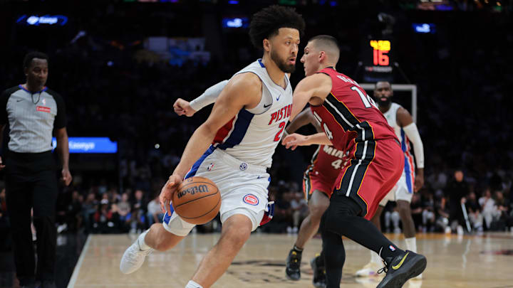 Mar 19, 2025; Miami, Florida, USA; Detroit Pistons guard Cade Cunningham (2) drives to the basket past Miami Heat guard Tyler Herro (14) during the fourth quarter at Kaseya Center. Mandatory Credit: Sam Navarro-Imagn Images