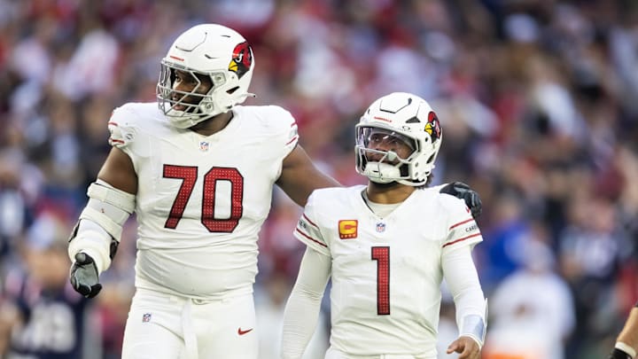 Dec 15, 2024; Glendale, Arizona, USA; Arizona Cardinals offensive tackle Paris Johnson Jr. (70) and quarterback Kyler Murray (1) against the New England Patriots at State Farm Stadium. Mandatory Credit: Mark J. Rebilas-Imagn Images