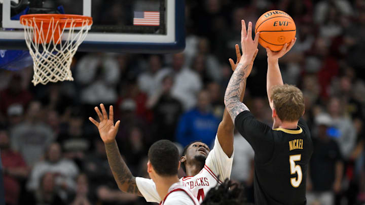 Mar 15, 2026; Nashville, TN, USA; Arkansas Razorbacks forward Billy Richmond III (24) defends against Vanderbilt Commodores forward Tyler Nickel (5) in the first half during the men's SEC Conference Tournament Championship at Bridgestone Arena. Mandatory Credit: Steve Roberts-Imagn Images