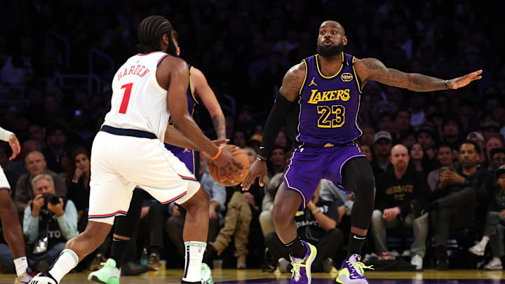 Feb 28, 2025; Los Angeles, California, USA; Los Angeles Lakers forward LeBron James (23) defends LA Clippers guard James Harden (1) during the fourth quarter at Crypto.com Arena. Mandatory Credit: Jason Parkhurst-Imagn Images