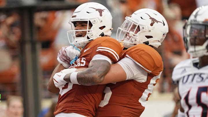 Sep 14, 2024; Austin, Texas, USA; Texas Longhorns wide receiver DeAndre Moore Jr. (0) and tight end Gunnar Helm (85) react after Moore Jr scored a touchdown during the first half against Texas-San Antonio at Darrell K Royal-Texas Memorial Stadium. Mandatory Credit: Scott Wachter-Imagn Images