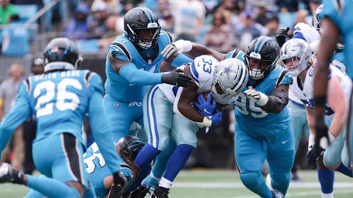 Oct 12, 2025; Charlotte, North Carolina, USA; Carolina Panthers linebacker Nic Scourton (11) and defensive end Derrick Brown (95) tackle Dallas Cowboys running back Javonte Williams (33) short of the goal line during the first quarter at Bank of America Stadium. Mandatory Credit: Scott Kinser-Imagn Images