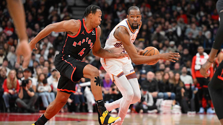 Feb 23, 2025; Toronto, Ontario, CAN;  Phoenix Suns forward Kevin Durant (35) dribbles the ball as Toronto Raptors forward Scottie Barnes (4) defends in the second half at Scotiabank Arena. Mandatory Credit: Dan Hamilton-Imagn Images