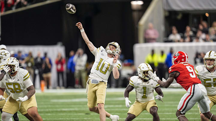 Nov 28, 2025; Atlanta, Georgia, USA; Georgia Tech Yellow Jackets quarterback Haynes King (10) throws a last chance pass to the end zone against the Georgia Bulldogs during the second half at Mercedes-Benz Stadium. Mandatory Credit: Dale Zanine-Imagn Images