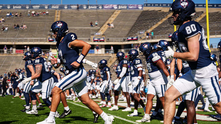 Sep 20, 2025; East Hartford, Connecticut, USA; Connecticut Huskies quarterback Joe Fagnano (2) and teammates warm up before the start of the game against the Ball State Cardinals at Pratt & Whitney Stadium at Rentschler Field. Mandatory Credit: David Butler II-Imagn Images