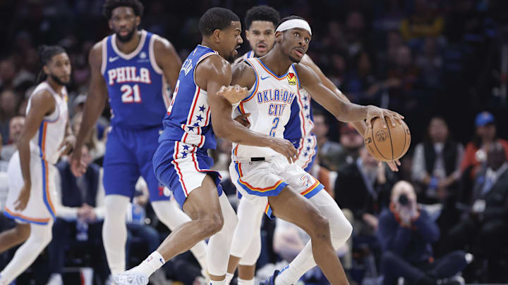 Nov 25, 2023; Oklahoma City, Oklahoma, USA; Oklahoma City Thunder guard Shai Gilgeous-Alexander (2) drives against Philadelphia 76ers guard De'Anthony Melton (8) during the second quarter at Paycom Center. Mandatory Credit: Alonzo Adams-Imagn Images
