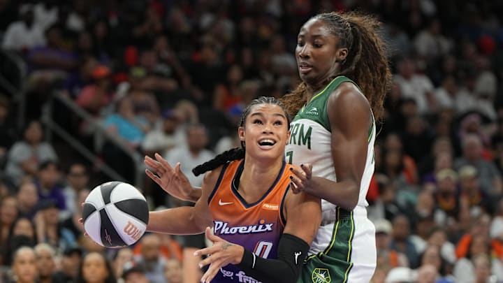 Jun 7, 2025; Phoenix, Arizona, USA; Phoenix Mercury forward Satou Sabally (0) drives on Seattle Storm forward Ezi Magbegor (13) in the second half at Footprint Center. Mandatory Credit: Rick Scuteri-Imagn Images