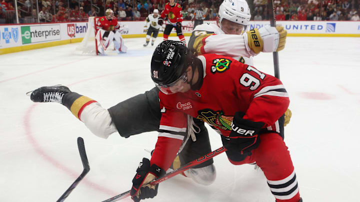 Mar 28, 2025; Chicago, Illinois, USA; Chicago Blackhawks center Frank Nazar (91) and Vegas Golden Knights center Jack Eichel (9) battle for control of the puck during the second period at United Center. Mandatory Credit: Talia Sprague-Imagn Images