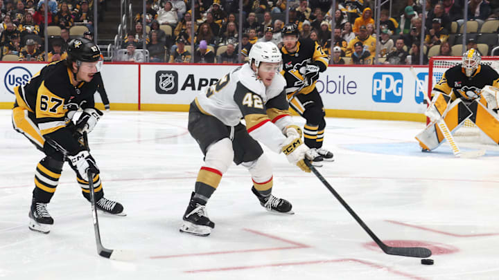 Mar 1, 2026; Pittsburgh, Pennsylvania, USA;  Vegas Golden Knights right wing Braeden Bowman (42) reaches for a loose puck ahead of Pittsburgh Penguins right wing Rickard Rakell (67) during the second period at PPG Paints Arena. Mandatory Credit: Charles LeClaire-Imagn Images