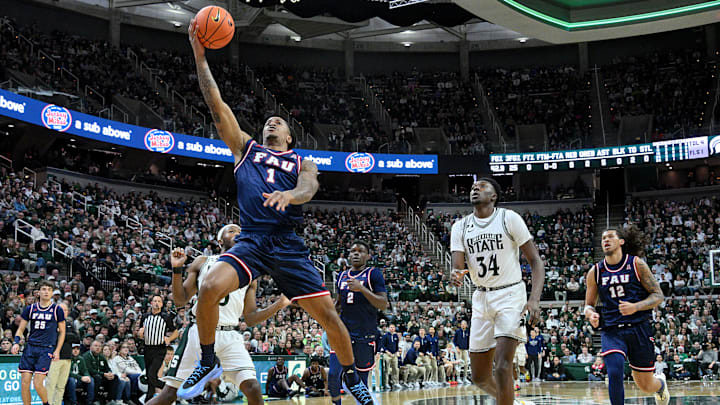 Dec 21, 2024; East Lansing, Michigan, USA;  Florida Atlantic Owls forward Kaleb Glenn (1) scores on a steal during the first half against the Michigan State Spartans at Jack Breslin Student Events Center. Mandatory Credit: Dale Young-Imagn Images