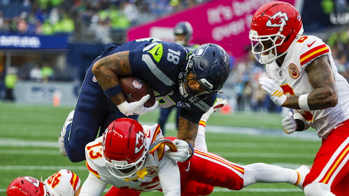 Seattle Seahawks tight end Elijah Arroyo (18) runs for yards after the catch against Kansas City Chiefs safety Nazeeh Johnson (13), linebacker Cole Christiansen (48) and safety Bryan Cook (6) during the first quarter at Lumen Field. 