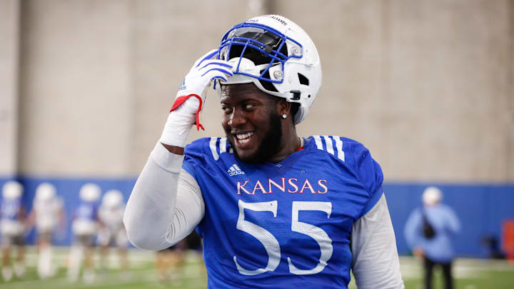 Kansas redshirt sophomore offensive lineman Ar'maj Reed-Adams (55) smiles during Tuesday's practice