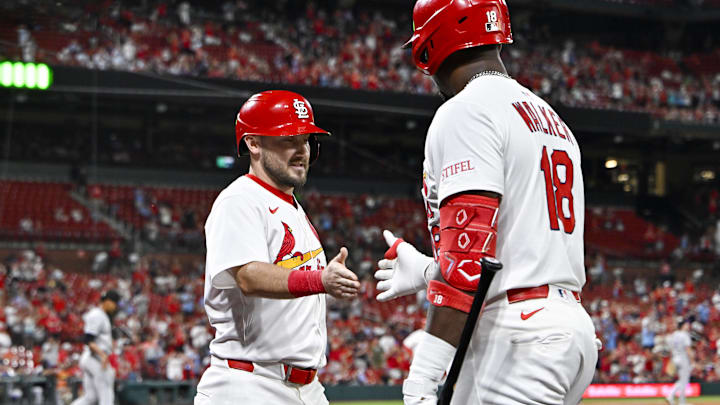 Aug 11, 2025; St. Louis, Missouri, USA;  St. Louis Cardinals pinch runner Garrett Hampson (13) is congratulated by right fielder Jordan Walker (18) after scoring against the Colorado Rockies during the eighth inning at Busch Stadium. Mandatory Credit: Jeff Curry-Imagn Images