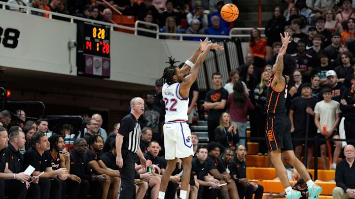 Kansas Jayhawks guard Darryn Peterson (22) shoots a 3-pointer over Oklahoma State Cowboys guard Vyctorius Miller (5) during a men's college basketball game between the Oklahoma State Cowboys and the Kansas Jayhawks at Gallagher-Iba Arena in Stillwater, Okla., Wednesday, Feb. 18, 2026.